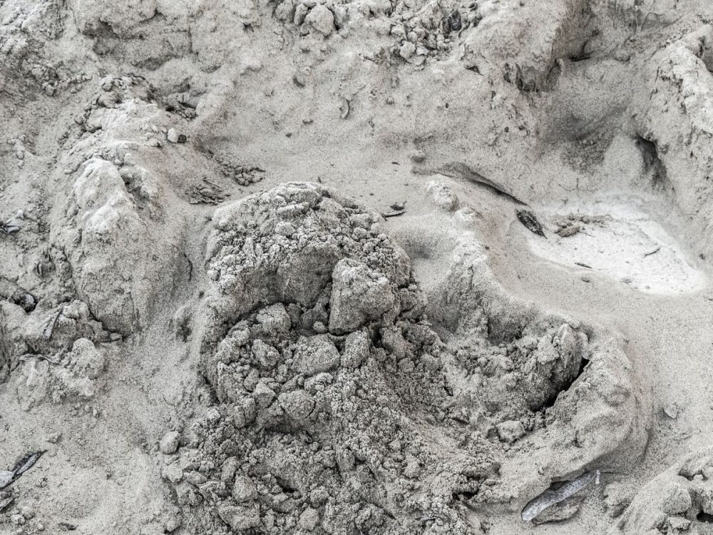 Excavated sandy soil during preparation for a pole foundation