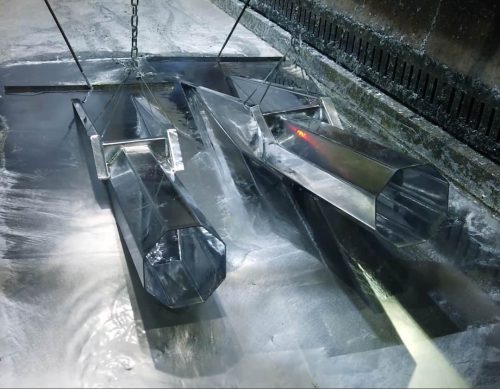 A galvanised steel pole emerging from molten zinc