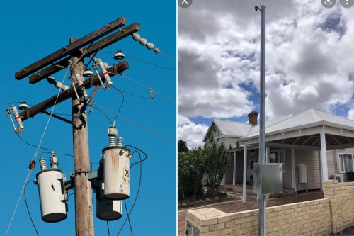 a wooden power pole next to a steel power pole